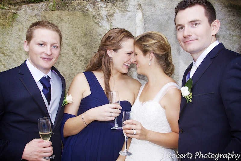 Bride and bridesmaid giggling together - wedding photography sydney